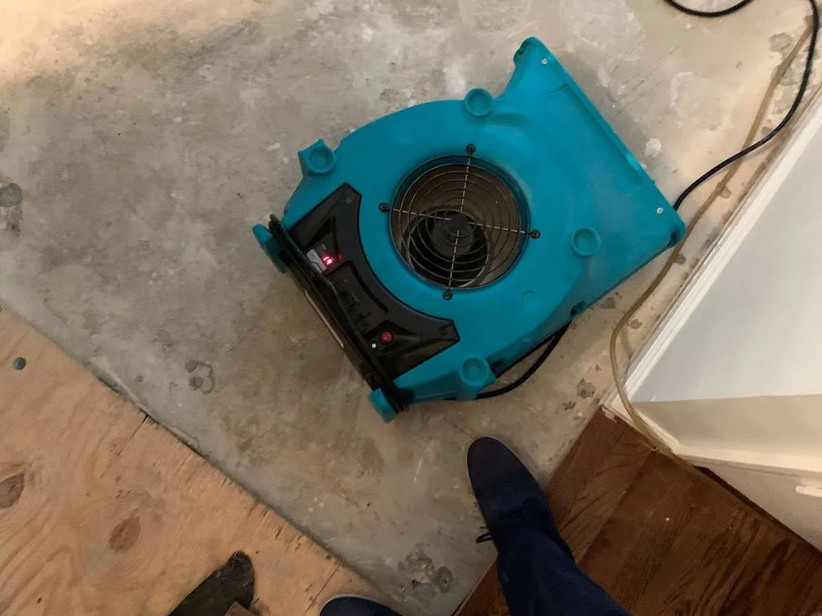 Air mover drying subfloor during Commercial Water Damage Restoration in Mahtomedi